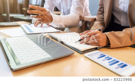 Business team brainstorming and discussing with financial data and report graph. Teamwork meeting working concept. 83223998