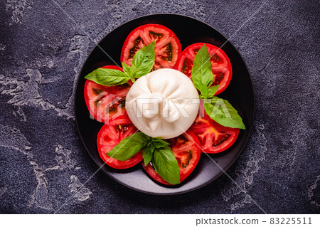 Tasty delicious buratta chese with fresh tomatoes 83225511