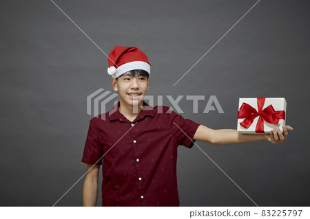 Christmas party man holding gift box Christmas party man holding gift box 83225797