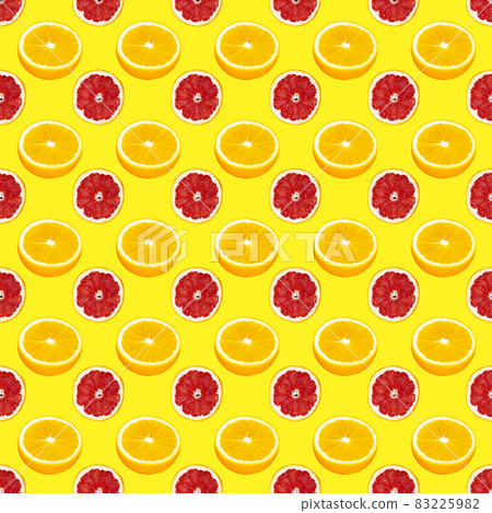 Fresh orange and grapefruit slices seamless pattern over yellow background, top view 83225982