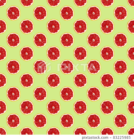 Fresh grapefuit slices seamless pattern over green background, top view Fresh grapefuit slices seamless pattern over green background, top view 83225985