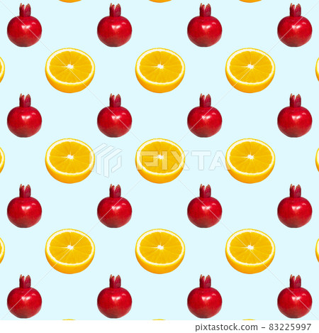 Pattern of a ripe red pomegranate on light blue background, Creative Food Concept, Flatlay Pattern of a ripe red pomegranate on light blue background, Creative Food Concept, Flatlay 83225997