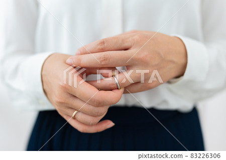 Woman trying to remove the ring Woman trying to remove the ring 83226306