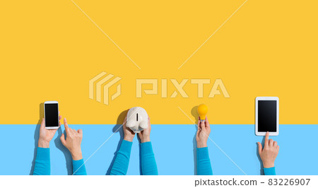 Technology devices and a piggy bank 83226907