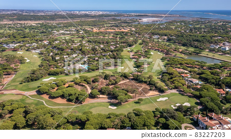 Aerial overview of luxury villas located around Quinta do Lago, Algarve, Portugal, Europe. Drone shot in the green zone. Aerial overview of luxury villas located around Quinta do Lago, Algarve, Portugal, Europe. Drone shot in the green zone. 83227203