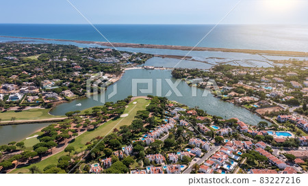Aerial overview of luxury villas located around Quinta do Lago, Algarve, Portugal, Europe. Drone shot in the green zone. Aerial overview of luxury villas located around Quinta do Lago, Algarve, Portugal, Europe. Drone shot in the green zone. 83227216