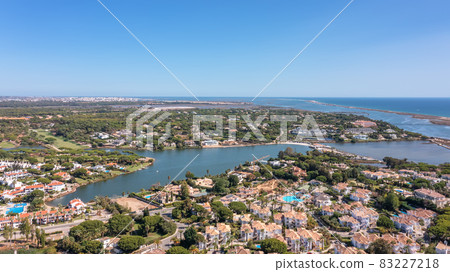 Aerial overview of luxury villas located around Quinta do Lago, Algarve, Portugal, Europe. Drone shot in the green zone. 83227218