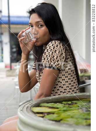 Woman drinking water 83228812