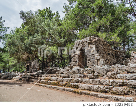 Ruins of ancient city Phaselis. Stones of damaged buildings. Agora of Domitian. Turkey. 83229498