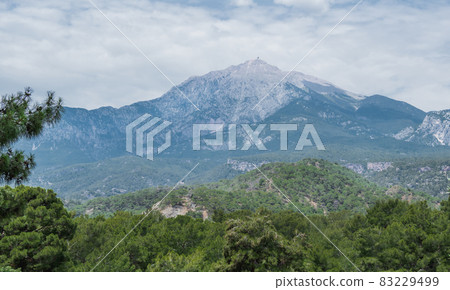 Mountain Tahtali Dagi, also known as Lycian Olympus among forests. Spring landscape. Turkey. 83229499