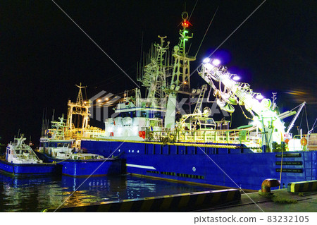 Night view photo of a fishing boat moored in the harbor at night_33 83232105
