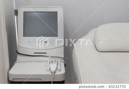 Medical apparatus for ultrasound therapy, massager, in the office of the clinic, for sick patients. Close-up. 83232735