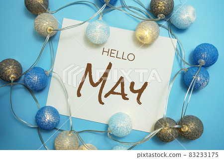 Hello May typography text with LED cotton ball on blue background Hello May typography text with LED cotton ball on blue background 83233175