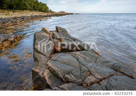 A rock against blue water. Picture from Skalderviken, Sweden A rock against blue water. Picture from Skalderviken, Sweden 83233255