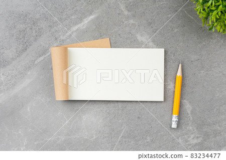 Open notepad on gray marble background. 83234477
