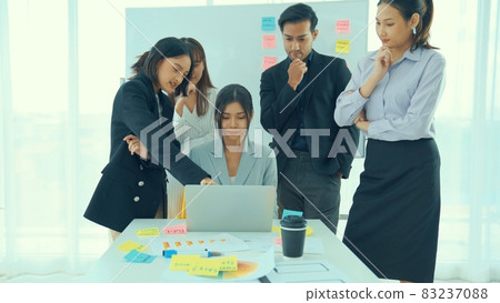 Business people proficiently discuss work project on computer 83237088