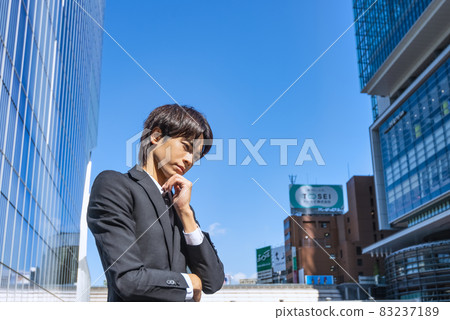 A worried young businessman cheek cane 83237189