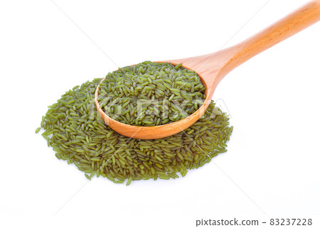 brown rice in wood spoon on white background brown rice in wood spoon on white background 83237228