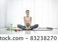 Portrait of young beautiful asian korean woman warm up exercise workout yoga position at home in living room. Sporty girl health care lifestyle. Yoga for beginner, wellbeing concept 83238270