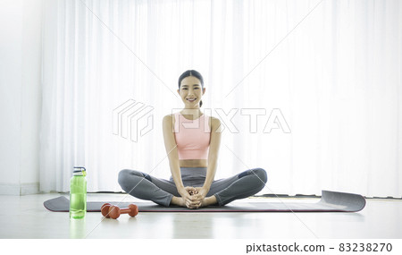 Portrait of young beautiful asian korean woman warm up exercise workout yoga position at home in living room. Sporty girl health care lifestyle. Yoga for beginner, wellbeing concept 83238270