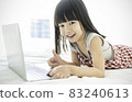 Portrait of asian girl typing on laptop computer studying in bed room, asian toddler girl look at notebook laptop screen. Education knowledge technology internet lifestyle, back to school concept 83240613