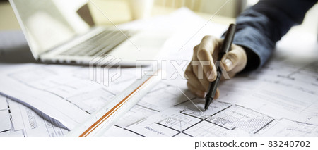 Close up woman hand working of Architect sketching project on blueprint at site construction work. Concept of architect, engineer in the office desk construction project banner Close up woman hand working of Architect sketching project on blueprint at site construction work. Concept of architect, engineer in the office desk construction project banner 83240702