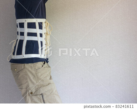 A man wearing a corset belt with back pain A man wearing a corset belt with back pain 83241611