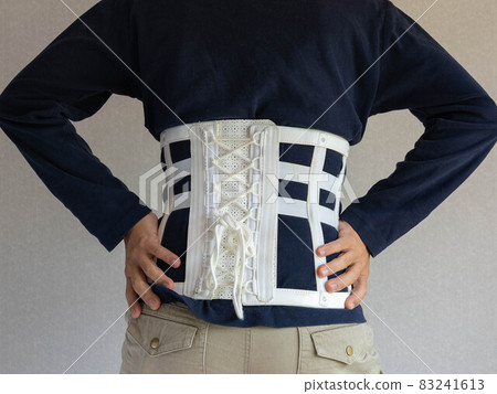 A man wearing a corset belt with back pain 83241613