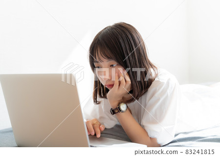 A woman staring down on her computer screen A woman staring down on her computer screen 83241815