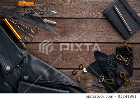 Leather products. Work place craftsman in a workshop. Top view 83241981