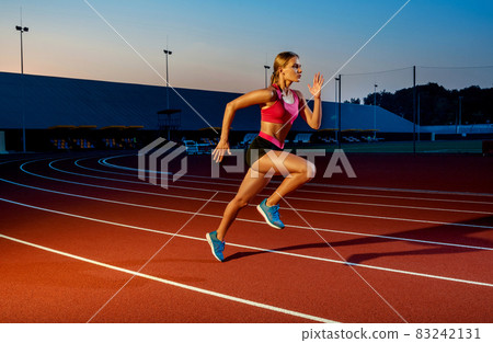 Runner sprinting towards success on run path running athletic track. Goal achievement concept. 83242131