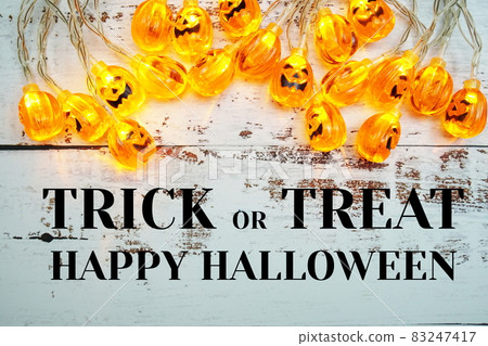 Trick or Treat typography text and Pumpkin Lights LED for Halloween Decorations on wooden background 83247417