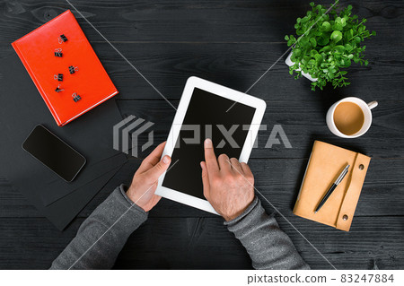 Directly above view of human hands with digital tablet. Directly above view of human hands with digital tablet. 83247884