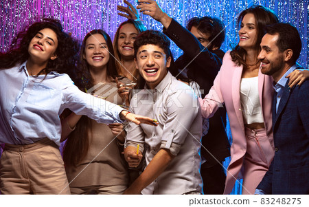 Young, happy, excited friends having fun at the party. New Year celebration gathering Young, happy, excited friends having fun at the party. New Year celebration gathering 83248275