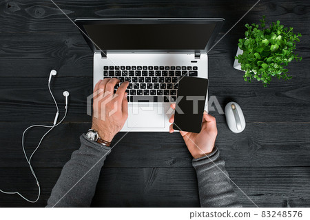 Directly above view of human hands typing on laptop. Directly above view of human hands typing on laptop. 83248576