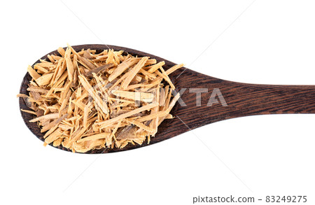Muira Puama herbal tea in wooden spoon, isolated on white background. Natural potency wood, medicinal plant, dry tea. Ptychopetalum olacoides. Top view. 83249275
