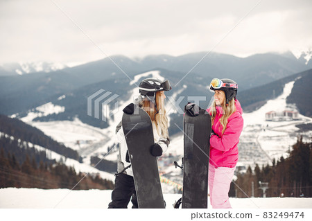 Girls snowboarding in the mountains with the snowboard 83249474