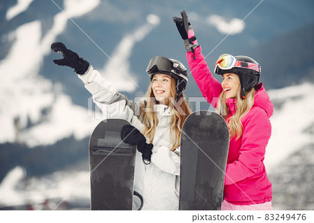 Girls snowboarding in the mountains with the snowboard 83249476