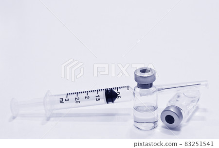 Vial of drugs or vaccine and 3 ml plastic syringe with needle isolated on the white background, blue tone color Vial of drugs or vaccine and 3 ml plastic syringe with needle isolated on the white background, blue tone color 83251541