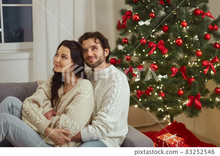 Loving Couple Celebration New Year Near Christmas Tree at Home 83252546