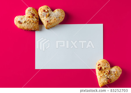 Valentine's day greeting card and cookies. Valentine's day blank greeting card and heart shaped cookies on pink background 83252703