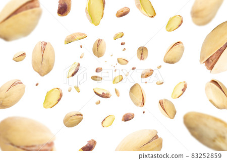 Collection of pistachio nuts falling isolated on white background. Selective focus Collection of pistachio nuts falling isolated on white background. Selective focus 83252859