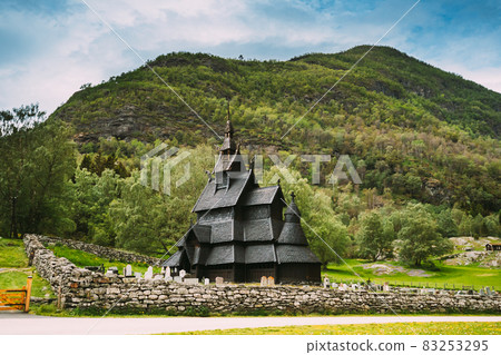 Borgund, Norway. Famous Landmark Stavkirke An Old Wooden Triple Nave Stave Church In Summer Day. Ancient Old Wooden Worship In Norwegian Countryside Landscape Borgund, Norway. Famous Landmark Stavkirke An Old Wooden Triple Nave Stave Church In Summer Day. Ancient Old Wooden Worship In Norwegian Countryside Landscape 83253295
