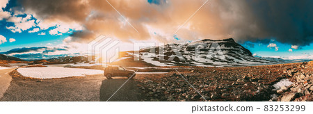 Aurlandsfjellet, Norway. Car SUV Parked Near Aurlandsfjellet Scenic Route Road In Summer Norwegian Landscape. Popular Destination In Sunset Lights. Panorama Aurlandsfjellet, Norway. Car SUV Parked Near Aurlandsfjellet Scenic Route Road In Summer Norwegian Landscape. Popular Destination In Sunset Lights. Panorama 83253299
