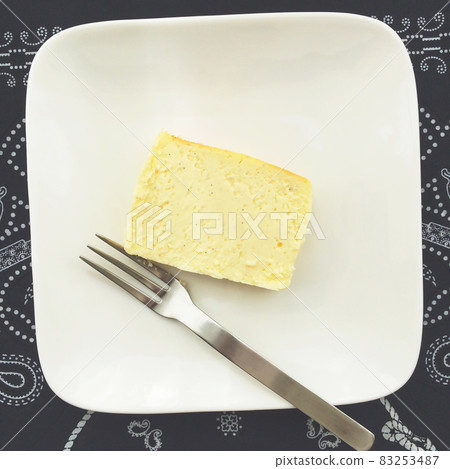 A piece of homemade cheesecake on a white plate 83253487