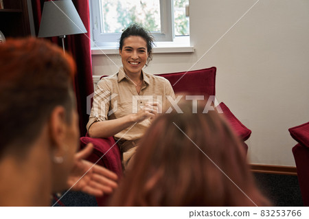Women visiting therapy, while sitting on couch at family psychologist appointment Women visiting therapy, while sitting on couch at family psychologist appointment 83253766