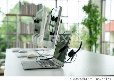 Headset and customer support equipment at call center ready for actively service 83254164