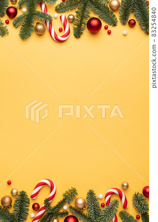 Yellow Christmas background with holiday border Yellow Christmas background with holiday border 83254840