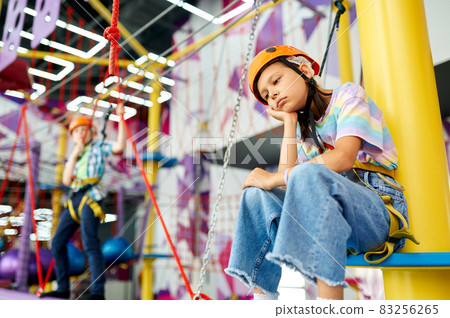 Tired girl in climbing area Tired girl in climbing area 83256265