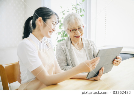Women in aprons and elderly women using tablets 83262483